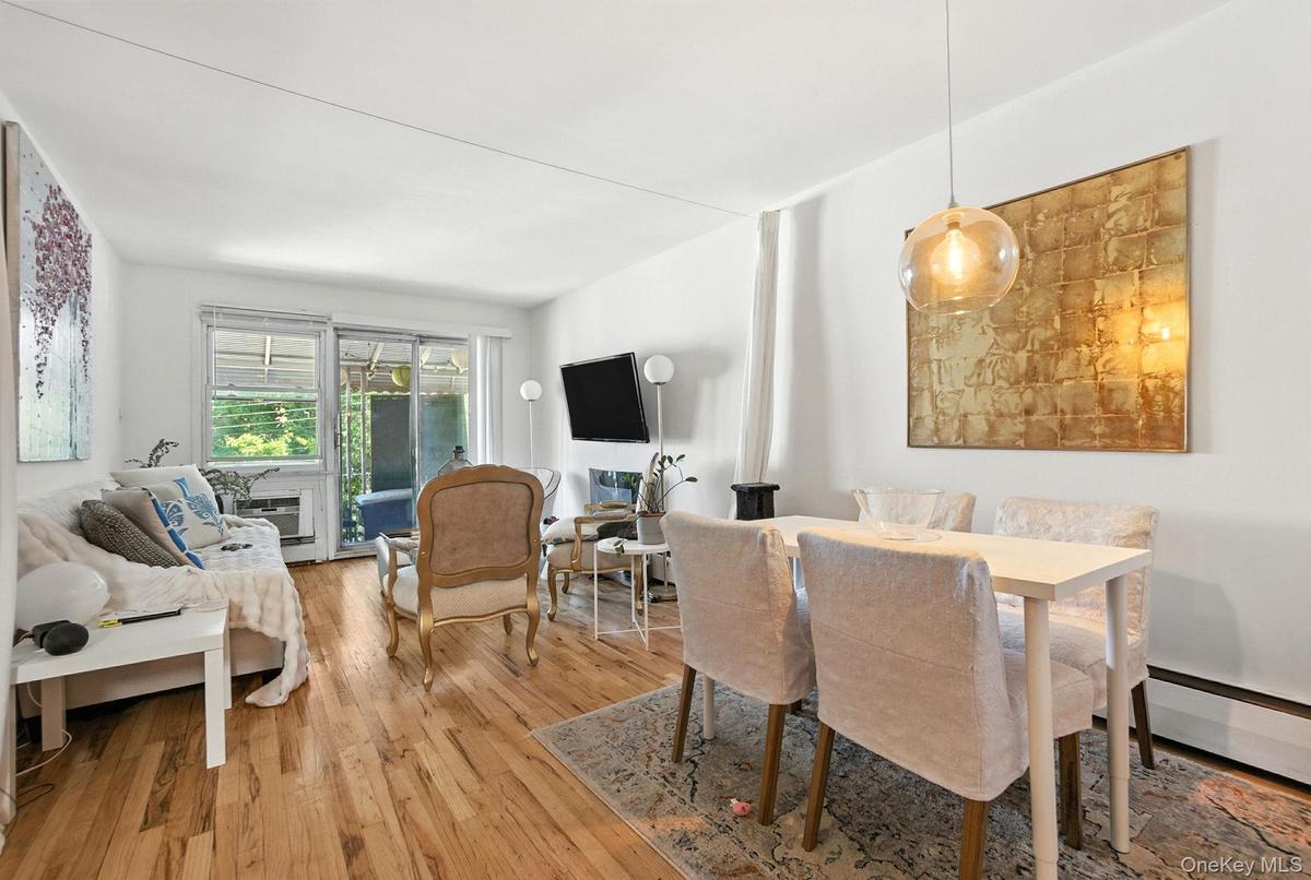 Dining space with hardwood / wood-style floors