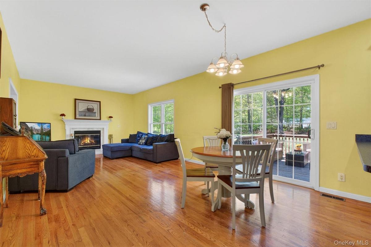 The sun filled family room features a wood burning fireplace.