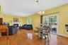 The sun filled family room features a wood burning fireplace.