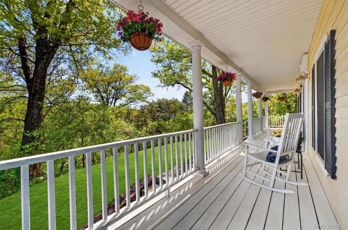 Enjoy summer nights on the expansive front porch with seasonal views of Lake Meahagh!