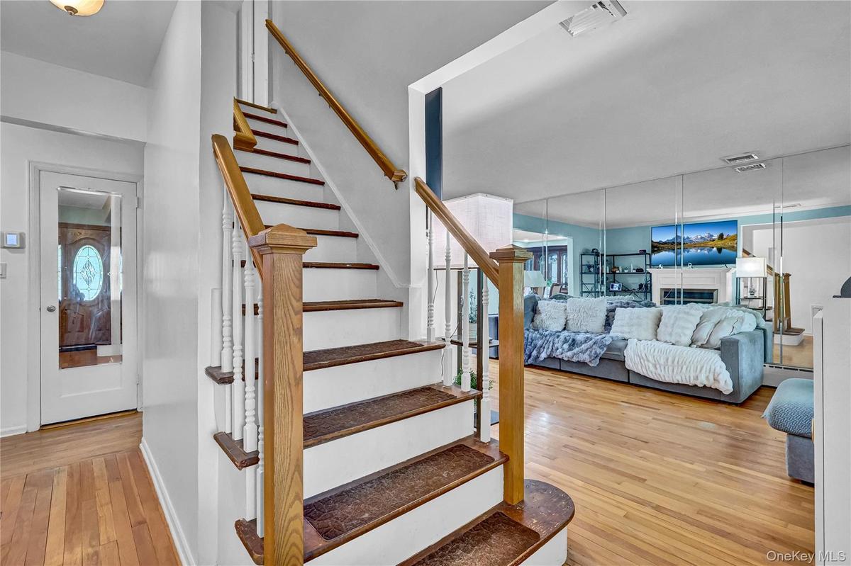 Hardwood flooring extending through the living area and entryway