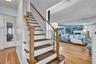 Hardwood flooring extending through the living area and entryway