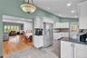 Kitchen featuring white cabinetry, dark countertops, a stainless steel refrigerator, and recessed lighting