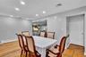 Dining area featuring wood-finish flooring, recessed lighting, and a mirrored wall panel