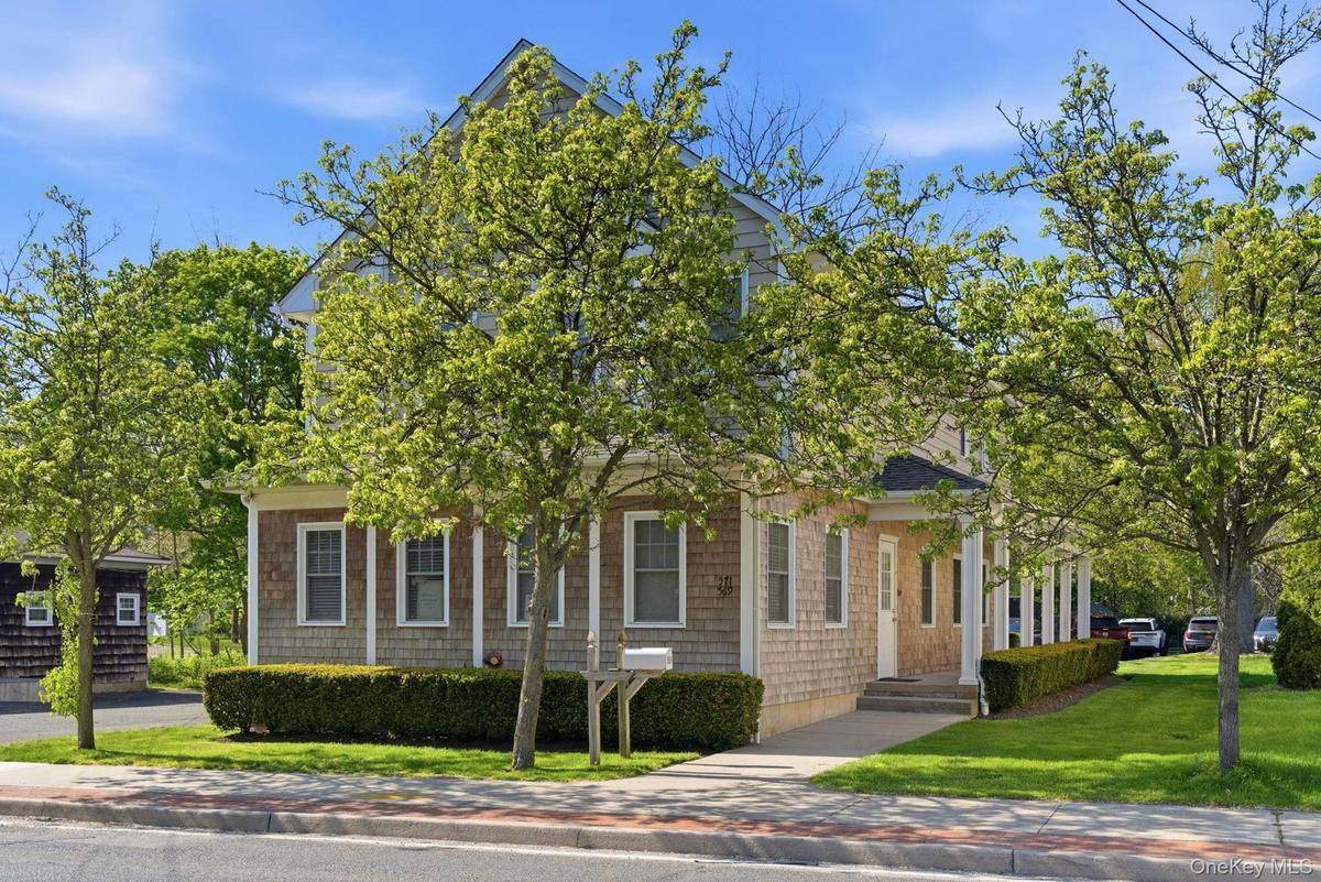 Two-story residence featuring shingle siding and a gabled roofline