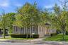 Two-story residence featuring shingle siding and a gabled roofline