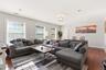 Open concept living area with recessed lighting, white trim, and multiple windows