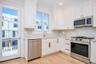 Another view of the kitchen with door out to deck.