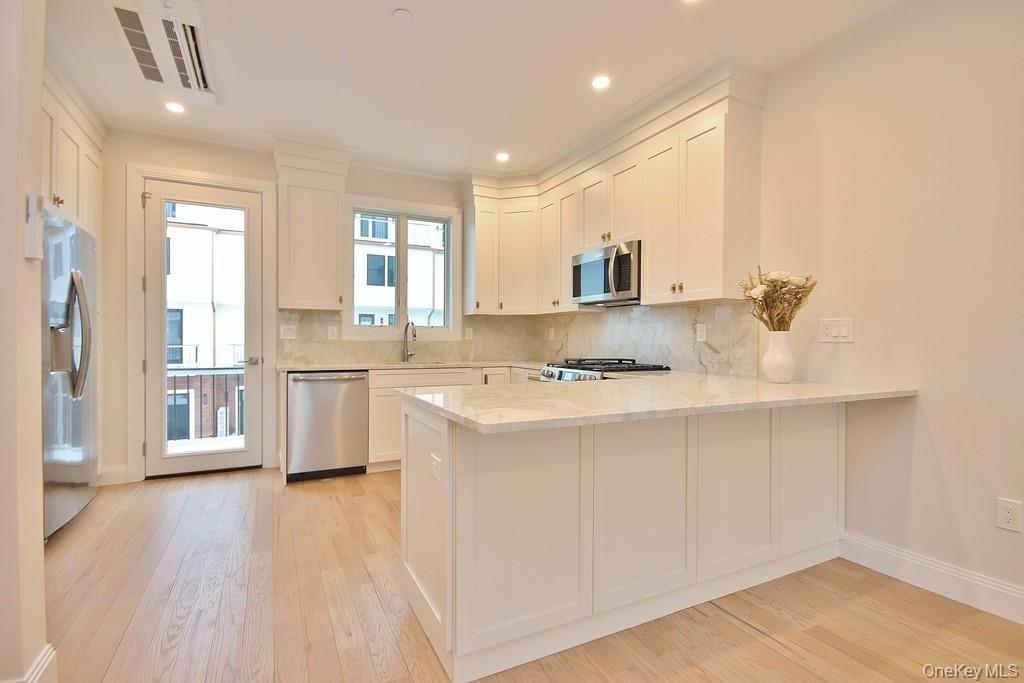 This sleek & stylish kitchen is a chef's dream, providing ample storage & workspace for all your culinary adventures.