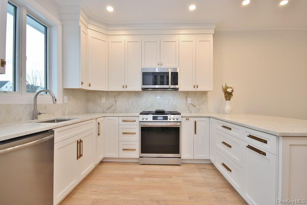 Designer kitchen with quartzite countertops, & stainless-steel appliances