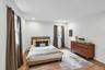 Room featuring wood-finish flooring, recessed lighting, white walls, and crown molding