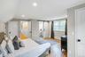 Room featuring wood-finish flooring, recessed lighting, and a white trim package