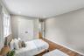 Bedroom featuring wood-finish flooring, recessed lighting, and a double-panel closet door