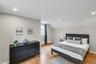 Spacious room featuring wood-finish flooring, recessed lighting, and a window with natural light