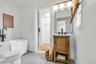 Bathroom featuring a freestanding tub with a floor-mounted matte black faucet