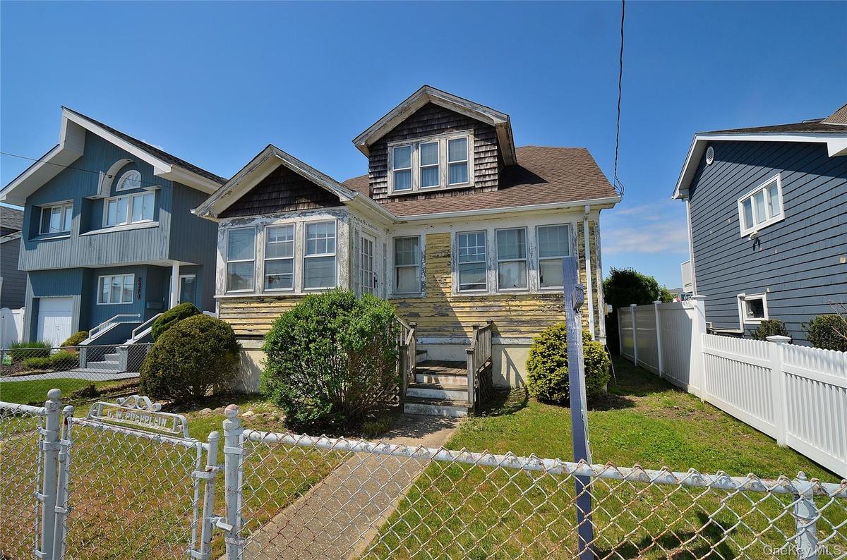 Two-story residence with a prominent gabled roofline and front bay window