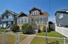 Two-story residence with a prominent gabled roofline and front bay window