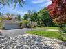 Side elevation with circular paver driveway & attached 2 car garage