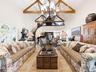 Formal Living Room with Fireplace, Soaring Double-Height Ceilings, and Architectural Beams