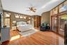 primary bedroom on first floor w/her & his California closets