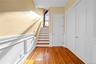 stairs to second floor with sitting area