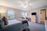 Carpeted with ceiling fan and views.