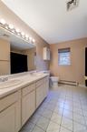2nd floor main bath with tiled floor, custom lighting and double vanity