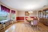 Oversized bay windows in spacious dining room