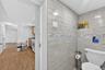 Tiled bathroom wall with decorative accent banding