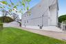 Expansive green lawn with a detached two-car garage and additional storage space