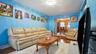 Living area featuring light blue wall finish and polished wood-finish flooring