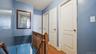 Hallway featuring wood-finish flooring, two-panel interior doors, and a wood banister
