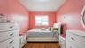 Bedroom featuring wood-finish flooring, a double window with blinds, and a flush-mount ceiling light