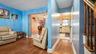 Hardwood flooring extending throughout the living space and hallway