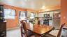 Kitchen featuring light grey cabinetry, stainless steel appliances, and a geometric tile backsplash