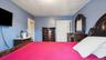 Spacious room featuring light blue walls and a white ceiling