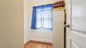 Room featuring wood-finish flooring, light-toned wall paint, and white baseboards