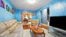 Living area with hardwood-finish flooring and a central ceiling light fixture