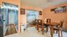 Dining area featuring tile flooring, a built-in ceiling light fixture, and a wide entryway