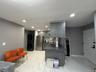 Kitchen with a peninsula, gray cabinets, appliances with stainless steel finishes, recessed lighting, and dark countertops