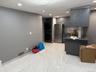 Kitchen with dark countertops, recessed lighting, a peninsula, freestanding refrigerator, and gray cabinetry