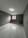 Spare room with light marble finish floors, a baseboard radiator, lofted ceiling, and a wall mounted air conditioner