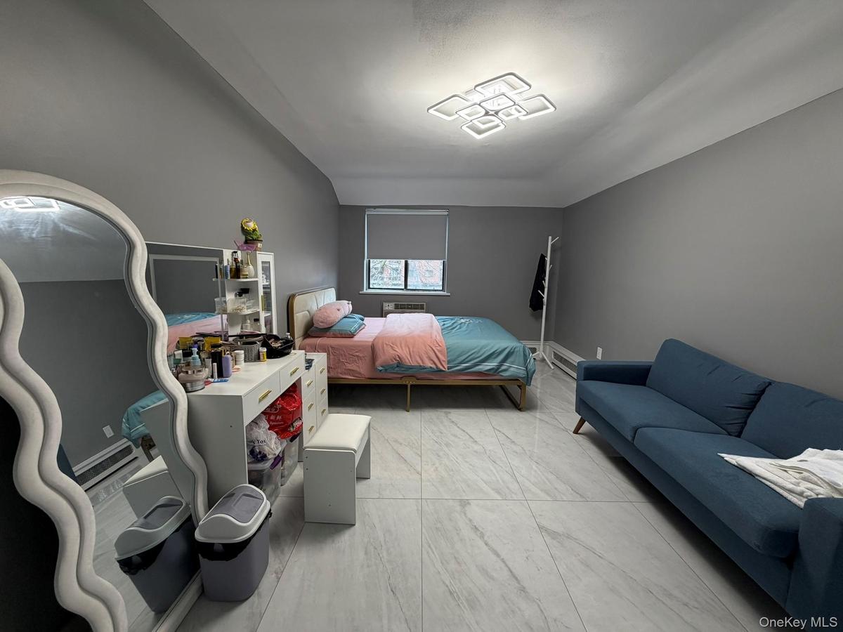 Bedroom featuring light marble finish flooring