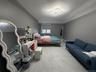 Bedroom featuring light marble finish flooring