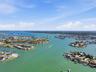 Aerial photo high above 4 Bellevue looking northwest towards Treasure Island Causeway drawbridge allowing access to the Gulf for larger sailboats and 