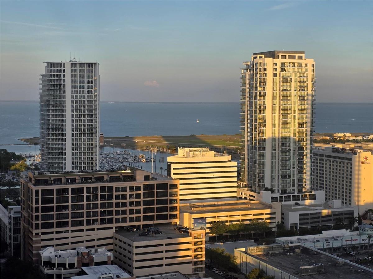 The Sun Glistens upon the City and Bay from your Private 60-foot Balcony at Sunset