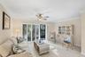 Living area with private tropical garden views, screened in lania and walk out