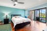 Primary suite with sliding doors to private screen enclosed balcony