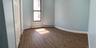 Bedroom#1 first floor featuring wood-finish flooring, light blue walls, and a multi-pane window