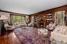 Formal living room with wood burning fireplace